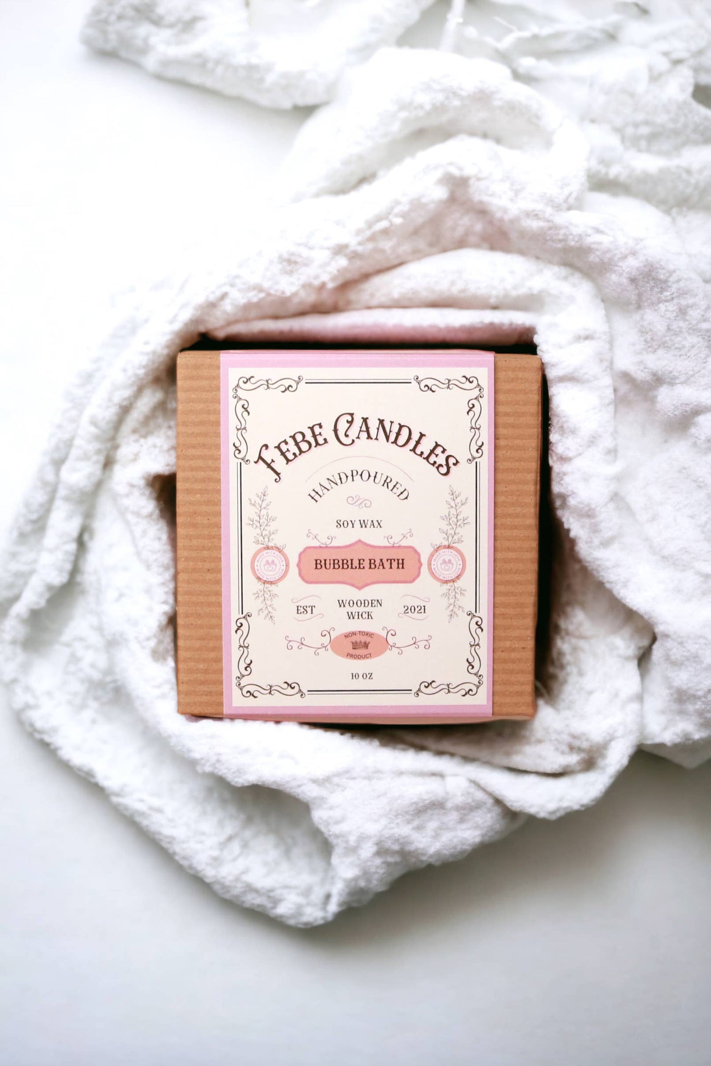 FEBE Candles bubble bath bar wrapped in a white towel on a light background
