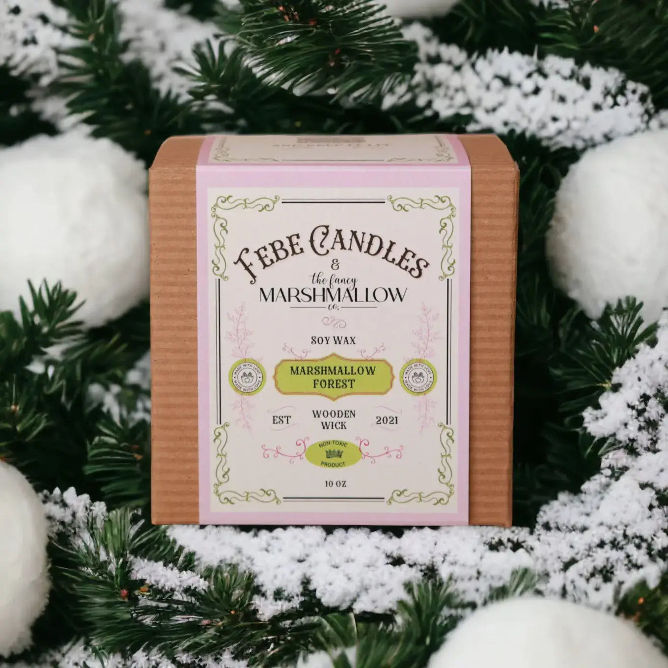 Fabe Candles Marshmallow Forest candle packaging with decorative greenery and snow in the background