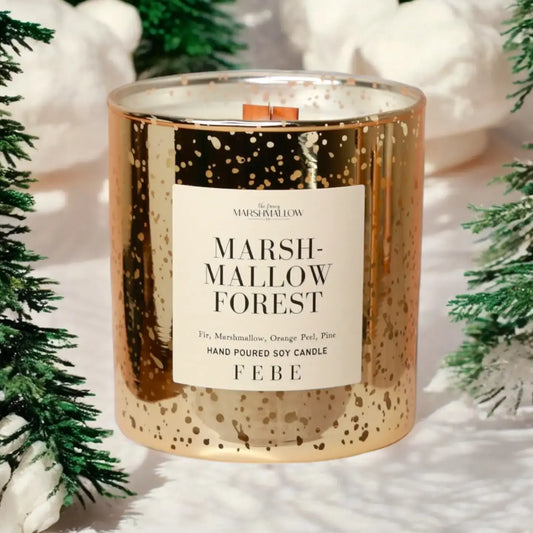 Candle labeled 'Marshmallow Forest' by Febe with decorative elements in the background