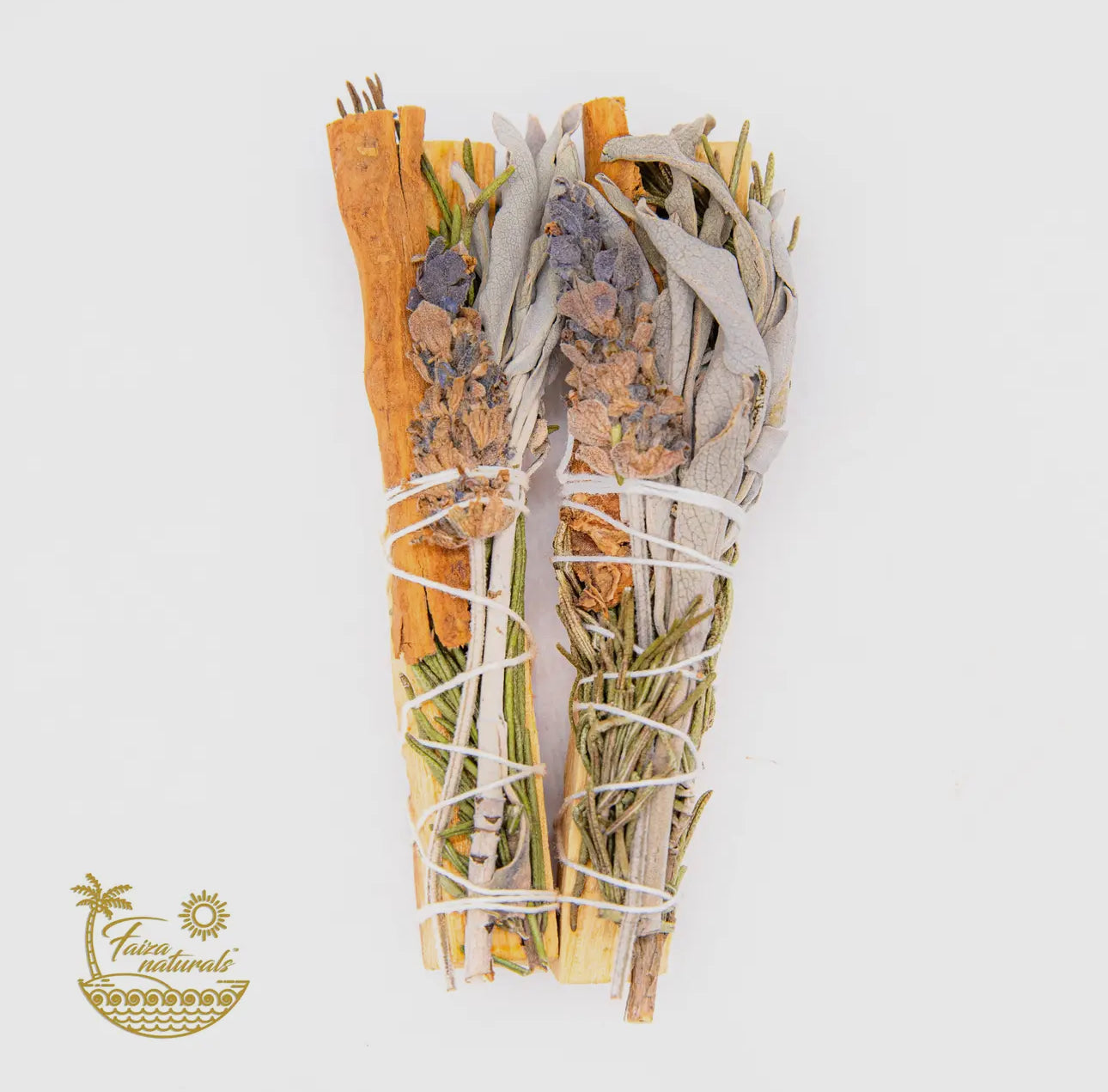 Four smudge sticks tied with string, comprising of Palo Santo wood and adorned with Rosemary, Lavender, and Sage leaves, against a white background.