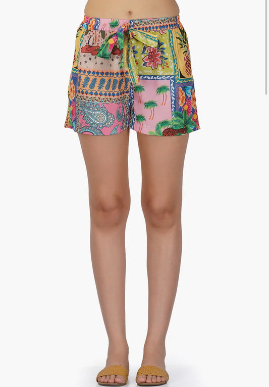 person wearing multicolored patterned shorts on a white background