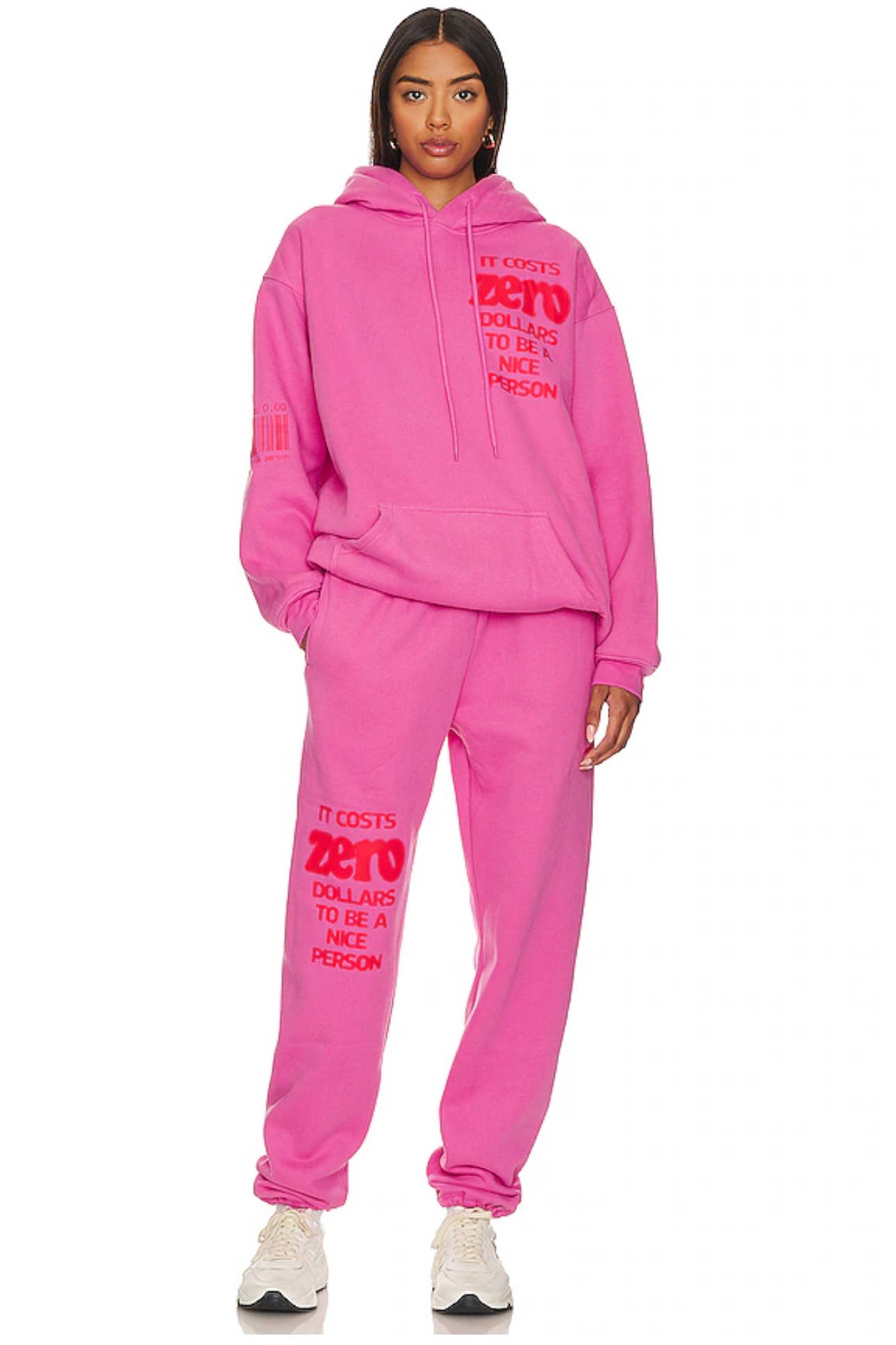 Person wearing a pink sweatsuit with text on a white background