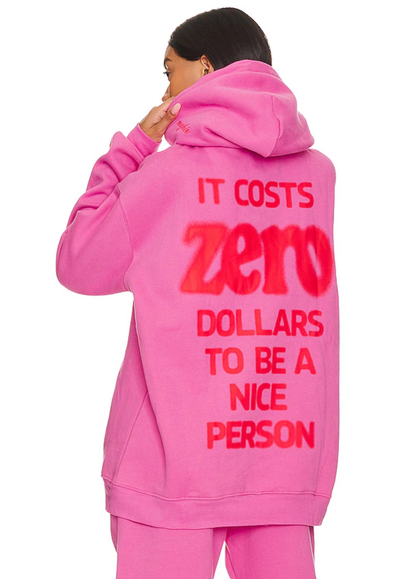 Person wearing a pink hoodie with a motivational message on the back