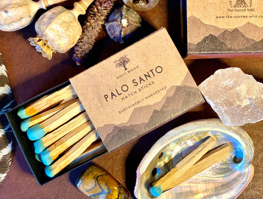 Box of Palo Santo matchsticks with matches on a stone surface