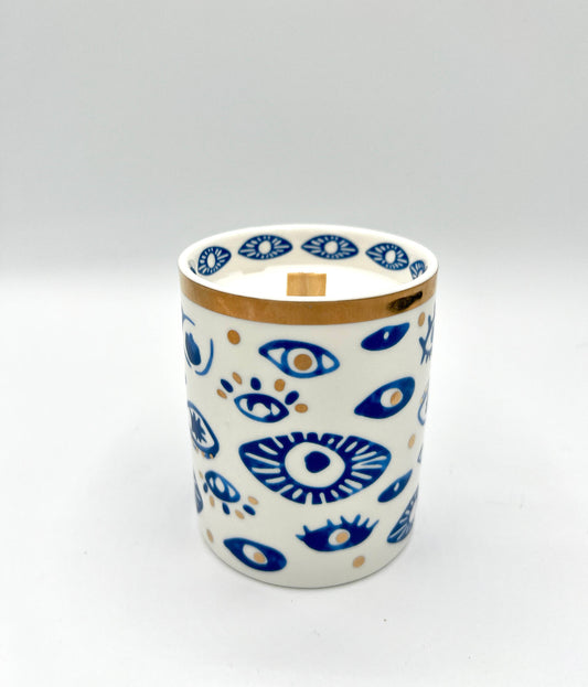 Ceramic mug with blue eye pattern on a white background