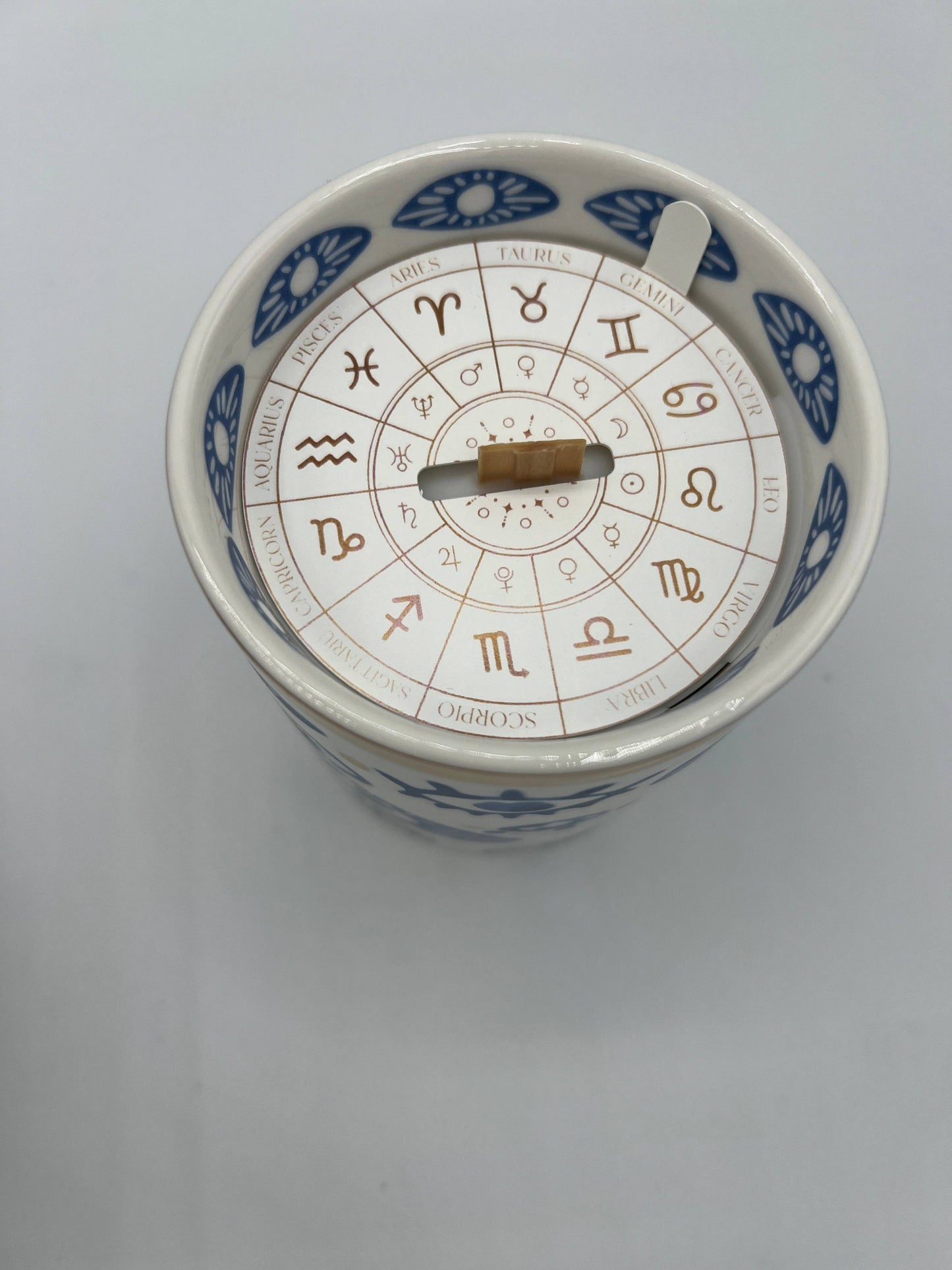 Ceramic jar with zodiac symbols on a white background