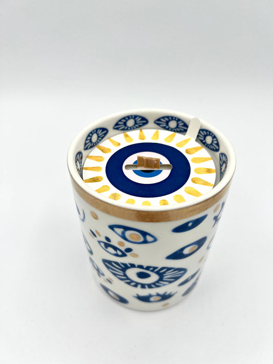 Ceramic tumbler with blue and white floral pattern on a white background