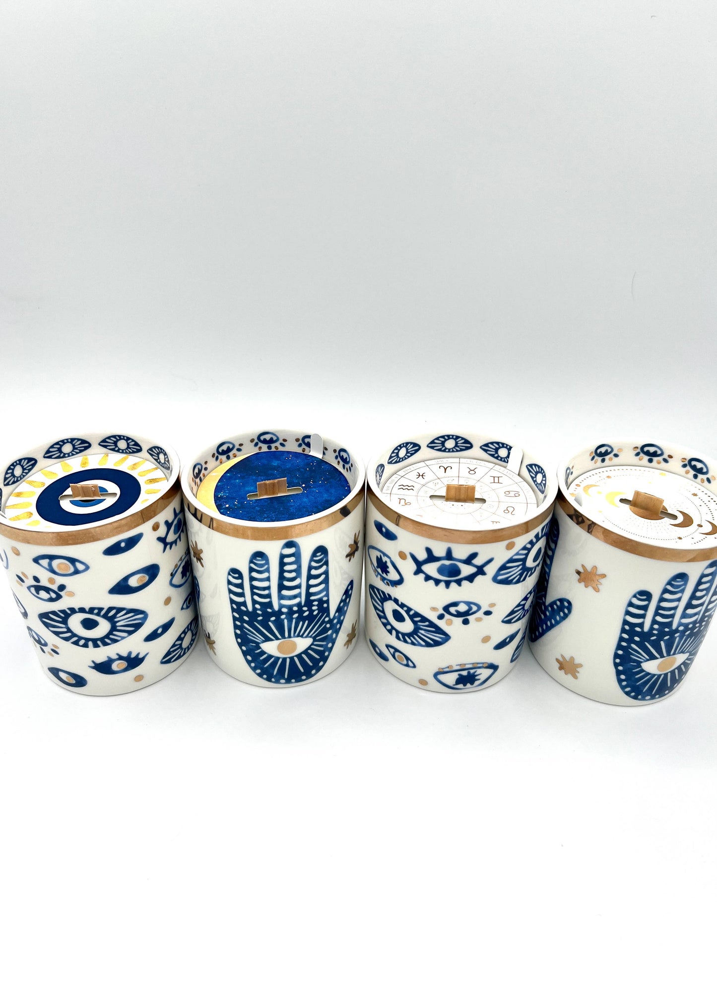 Four ceramic jars with decorative patterns on a white background
