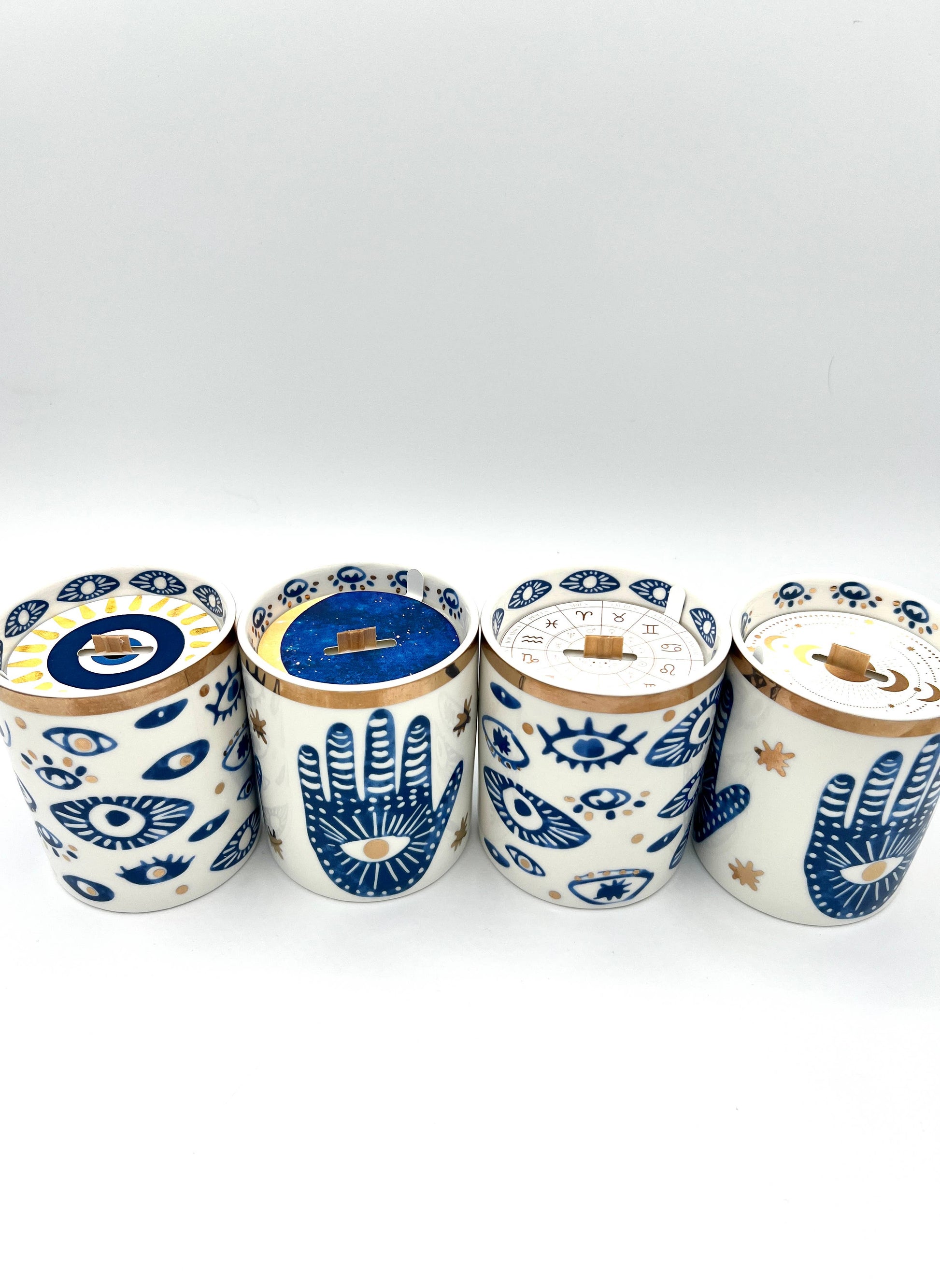 Four ceramic jars with decorative patterns on a white background