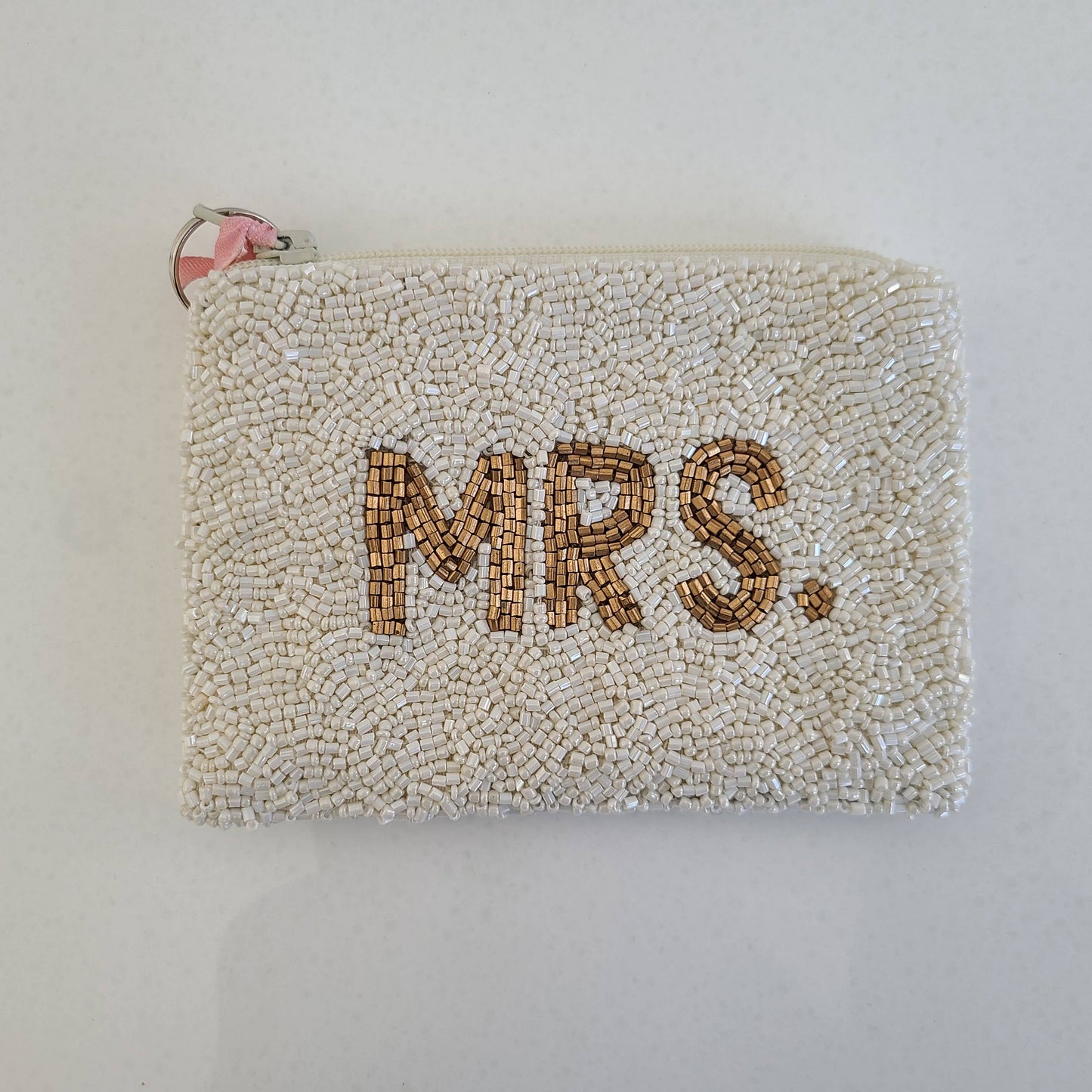 white beaded pouch with 'MRS.' text on a plain background