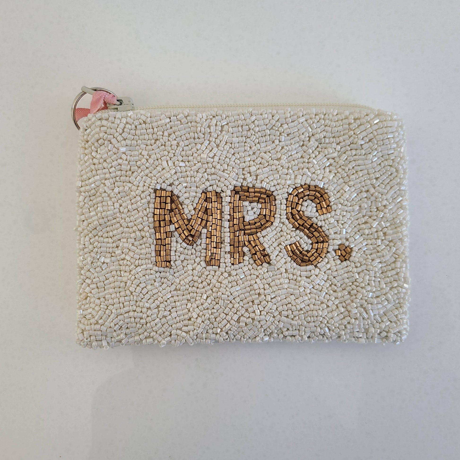 white beaded pouch with 'MRS.' text on a plain background