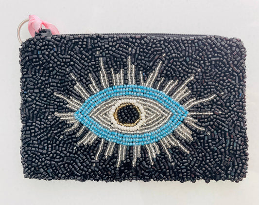 Black beaded pouch with an eye design on a white background