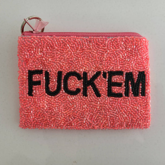Pink beaded pouch with 'FUCK'EM' text on a gray background